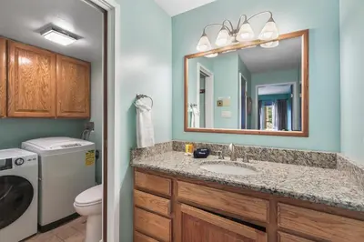 a bathroom with a sink and a washer and dryer at Lake Cliffe E201 by Great Western Lodging in Dillon