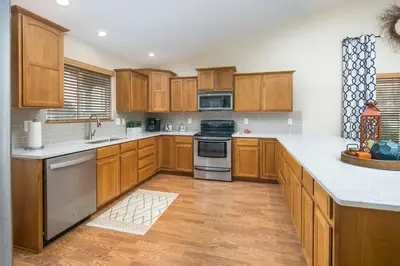 a large kitchen with wooden cabinets and stainless steel appliances at Parkview Retreat in Windsor