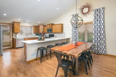 a kitchen with a wooden table and chairs in a kitchen at Parkview Retreat in Windsor