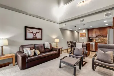 a living room with a couch and a kitchen at Mountain View Getaway by Great Western Lodging in Frisco