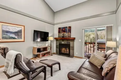 a living room with a couch and a fireplace at Mountain View Getaway by Great Western Lodging in Frisco