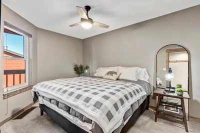a bedroom with a bed and a ceiling fan at Mountain View Getaway by Great Western Lodging in Frisco