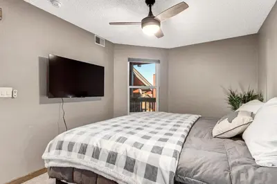 a bedroom with a bed and a flat screen tv at Mountain View Getaway by Great Western Lodging in Frisco