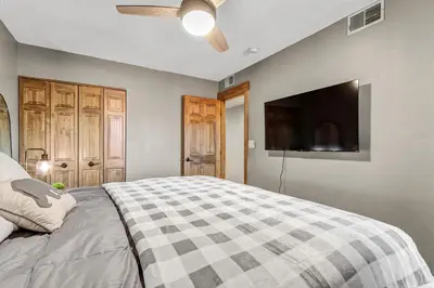 a bedroom with a bed and a flat screen tv at Mountain View Getaway by Great Western Lodging in Frisco