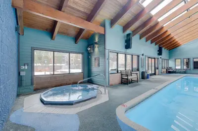 a large indoor pool with a hot tub in a building at Mountainside B173 by Great Western Lodging in Frisco