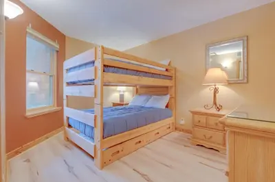 a bedroom with a bunk bed and a desk at Mountainside B173 by Great Western Lodging in Frisco
