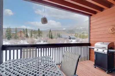 a screened in porch with a table and a large window at Mountainside B173 by Great Western Lodging in Frisco