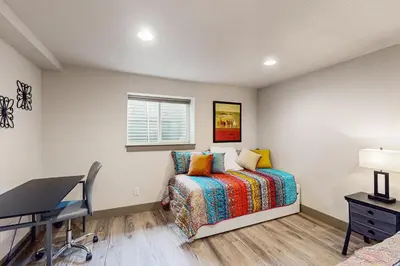 a bedroom with a bed and a desk and a window at Easy Commuting! Renovated Greeley Apartment in Greeley