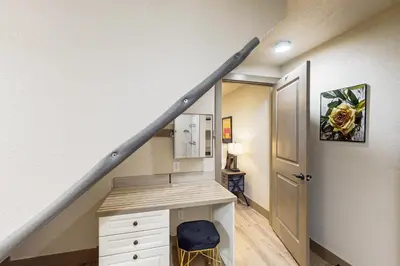 a room with a staircase with a desk and a mirror at Easy Commuting! Renovated Greeley Apartment in Greeley