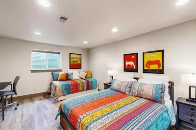 a bedroom with two beds and a desk at Easy Commuting! Renovated Greeley Apartment in Greeley