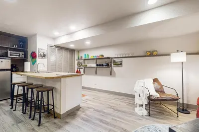 a kitchen with a counter and stools in a room at Easy Commuting! Renovated Greeley Apartment in Greeley