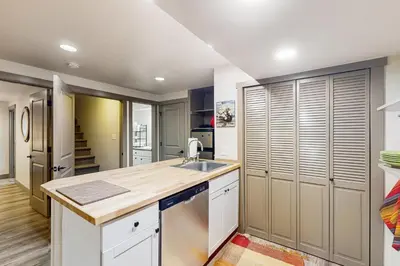 a kitchen with white cabinets and a sink at Easy Commuting! Renovated Greeley Apartment in Greeley