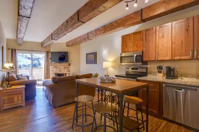 a kitchen and living room with a table and chairs at Ten Mile Creek 115 by Great Western Lodging in Frisco