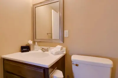 a bathroom with a sink and a toilet and a mirror at Ten Mile Creek 115 by Great Western Lodging in Frisco