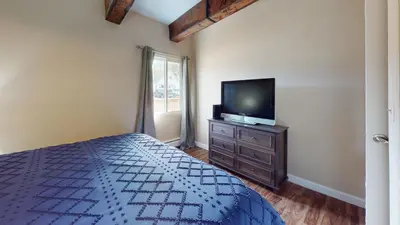 a bedroom with a bed and a tv on a dresser at Ten Mile Creek 115 by Great Western Lodging in Frisco