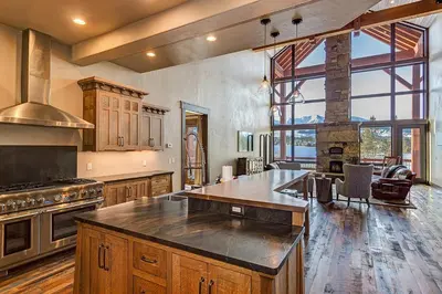 a large kitchen with wooden cabinets and a large window at The Observatory by Great Western Lodging in Breckenridge