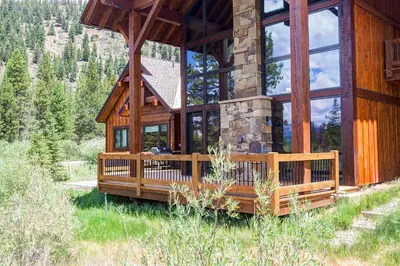 a large wooden house with a large window at The Observatory by Great Western Lodging in Breckenridge
