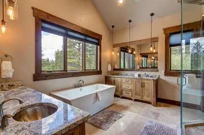 a bathroom with a tub and a sink and a shower at The Observatory by Great Western Lodging in Breckenridge