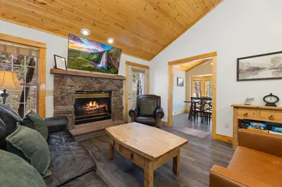 a living room with a couch and a fireplace at Antlers Pointe 1 by Estes Park Condos in Estes Park