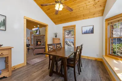 a dining room with a table and chairs and a ceiling fan at Antlers Pointe 1 by Estes Park Condos in Estes Park