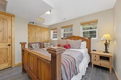 a bedroom with a bed with a wooden bed frame at Antlers Pointe 1 by Estes Park Condos in Estes Park