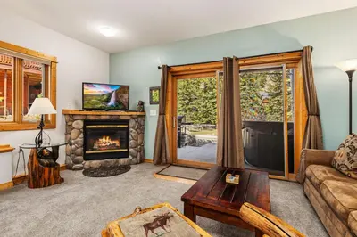 a living room with a couch and a fireplace at Bugle Pointe A02 by Estes Park Condos in Estes Park