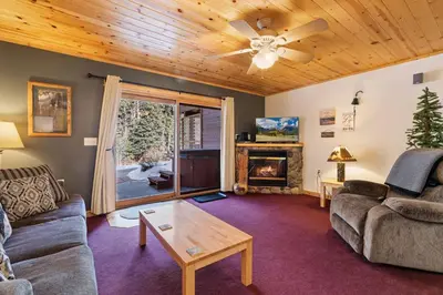 a living room with a couch and a fireplace at Bugle Pointe B10 by Estes Park Condos in Estes Park