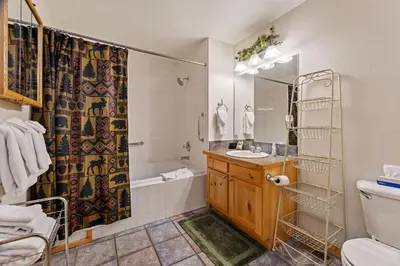 a bathroom with a tub and a sink and a shower at Bugle Pointe B10 by Estes Park Condos in Estes Park