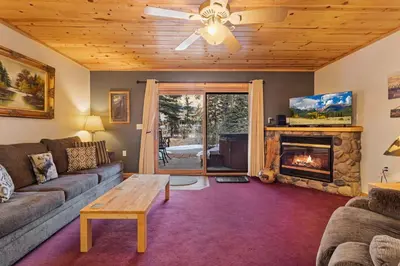 a living room with a couch and a fireplace at Bugle Pointe B10 by Estes Park Condos in Estes Park