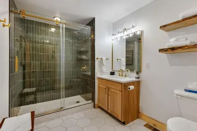 a bathroom with a shower and a sink and a toilet at Bugle Pointe B12 by Estes Park Condos in Estes Park