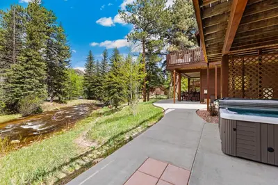 a home with a swimming pool next to a house at Bugle Pointe B12 by Estes Park Condos in Estes Park