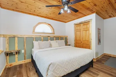 a bedroom with a bed and a ceiling fan at Bugle Pointe B12 by Estes Park Condos in Estes Park