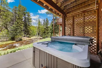 a jacuzzi tub in a wooden house at Bugle Pointe B12 by Estes Park Condos in Estes Park