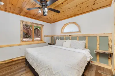 a bedroom with a bed and a ceiling fan at Bugle Pointe B12 by Estes Park Condos in Estes Park