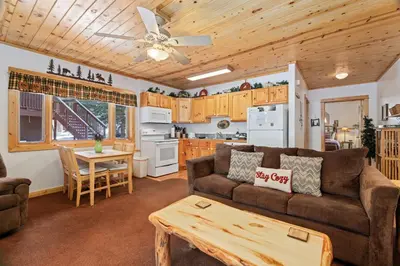 a living room with a couch and a table at Bugle Pointe B18 by Estes Park Condos in Estes Park