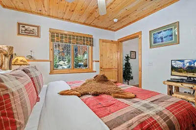 a bedroom with a bed with a pile of fur at Bugle Pointe B18 by Estes Park Condos in Estes Park