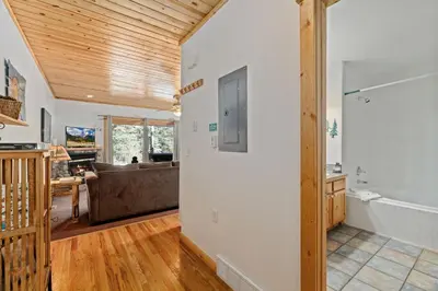 a living room with a wooden ceiling at Bugle Pointe B18 by Estes Park Condos in Estes Park