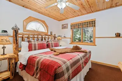 a bedroom with a bed with a teddy bear on it at Bugle Pointe B18 by Estes Park Condos in Estes Park