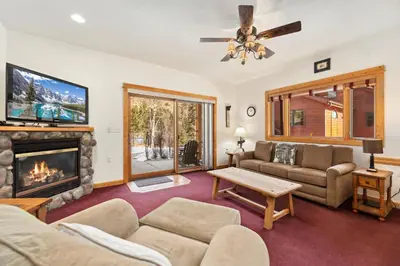 a living room with a couch and a fireplace at Bugle Pointe A05 by Estes Park Condos in Estes Park