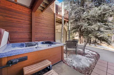 a hot tub on the side of a house at Bugle Pointe A16 by Estes Park Condos in Estes Park