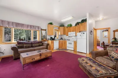 a living room with a couch and a table at Bugle Pointe A16 by Estes Park Condos in Estes Park