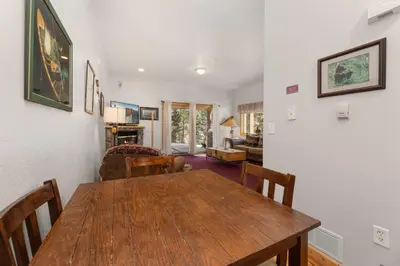 a dining room with a wooden table and chairs at Bugle Pointe A16 by Estes Park Condos in Estes Park