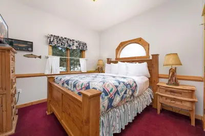 a bedroom with a bed and a window at Bugle Pointe A16 by Estes Park Condos in Estes Park