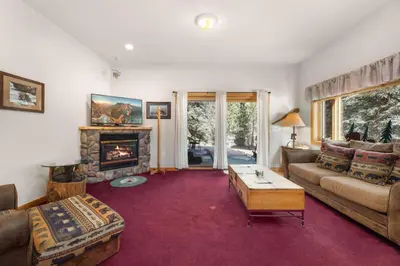 a living room with a couch and a fireplace at Bugle Pointe A16 by Estes Park Condos in Estes Park