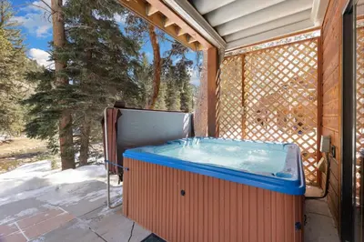 a hot tub on the side of a house at Bugle Pointe B14 by Estes Park Condos in Estes Park