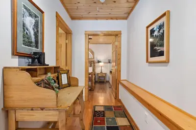 a hallway with a wooden table in a house at Bugle Pointe B14 by Estes Park Condos in Estes Park