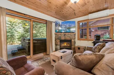 a living room with a couch and a fireplace at Bugle Pointe B20 by Estes Park Condos in Estes Park
