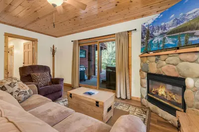 a living room with a fireplace and a couch at Bugle Pointe B20 by Estes Park Condos in Estes Park