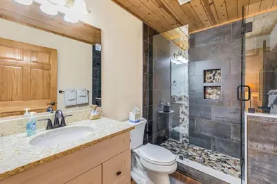 a bathroom with a toilet sink and a shower at Bugle Pointe B20 by Estes Park Condos in Estes Park