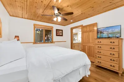 a bedroom with a white bed and a ceiling fan at Bugle Pointe B20 by Estes Park Condos in Estes Park